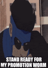 a man in a blue mask and sunglasses is standing in front of a building .