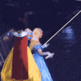 a doll dressed as snow white and cinderella walking on a stage