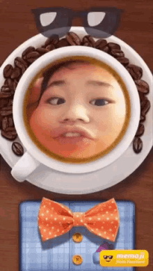 a cup of coffee with a child 's face in it and a bow tie