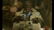 a man in a suit is typing on a typewriter