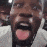 a close up of a man with his tongue out .