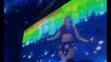 a woman in a cow print skirt is dancing on stage
