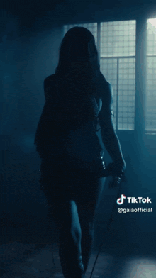 a woman covering her face with her hands and a tiktok sticker