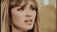 a close up of a woman 's face with tears running down her face .