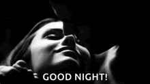 a man is kissing a woman on the forehead in a black and white photo and says `` good night '' .