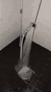 a mop is being used to clean the drain in a bathroom