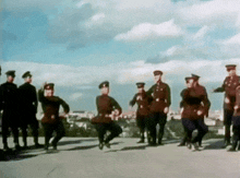 a group of soldiers are dancing in front of a city