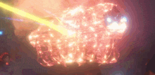 a person is standing in front of a large fireball with a light coming out of it .