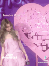 a woman in a pink dress stands in front of a pink heart shaped wall with sticky notes on it