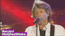 a man singing into a microphone with the words bonjovi motijheel dhaka below him