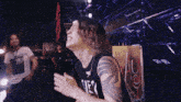 a man with a tattoo on his arm wears a black shirt that says ones