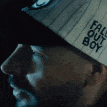 a man is wearing a hat that says fall out boy