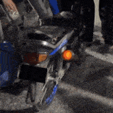 a motorcycle with a license plate that has a sticker that says ' honda ' on it