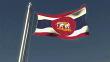 a red white and blue flag with an elephant in the center
