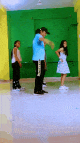 a group of young girls are dancing with a man wearing black pants that say limitless