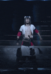 a man without a shirt is dancing on a stage