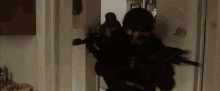 a group of soldiers are walking through a doorway while holding guns