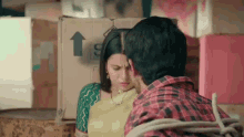 a man and a woman are tied together with a rope and standing next to a cardboard box .