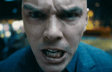 a close up of a man 's face with a very angry look on his face