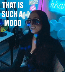 a woman wearing sunglasses with the words that is such a mood