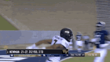 a football game is being played and j. newman is running for the ball