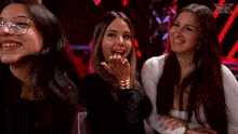 three women are posing for a picture with an x on the back