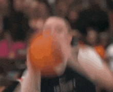 a blurry picture of a man holding a basketball with the word mavericks visible