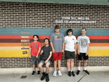 a group of young men standing in front of a brick wall that says hershey park happy