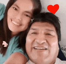 a man and a girl are posing for a picture with a red heart above their heads