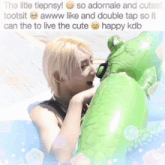a picture of a boy with a green inflatable frog with the caption the little tiepnsy