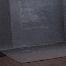 a painting of a cloudy sky is sitting on a table in a room .