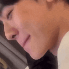 a close up of a person 's face with their eyes closed and their mouth open .