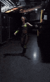 a woman in a green and black outfit with the words the prodigy is going to the elimination chamber on the bottom