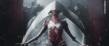 a statue of a woman with a red face and a sword