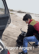 a man is working on a car engine with the words argent argent written on the bottom