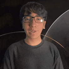 a man wearing glasses and a shirt that says clay on it