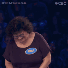 a woman with a name tag that says paula holds her head