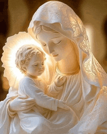 a white statue of a woman holding a child