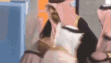 a man in a pink turban is standing in front of a blue box .