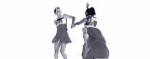 three cheerleaders are standing next to each other on a white background in a black and white photo .