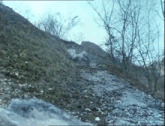 a person is laying on the ground on a dirt road .