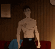 a shirtless man is standing in front of a wooden wall .