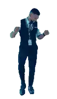 a man wearing a vest and tie is smiling while standing