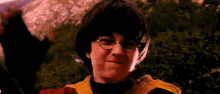 harry potter is wearing glasses and a yellow jacket in a scene from harry potter and the philosopher 's stone .