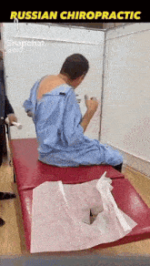 a man in a blue gown is sitting on a red table with the words russian chiropractic above him