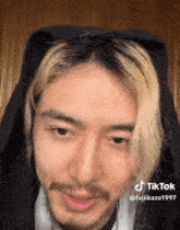 a close up of a man 's face with a tik tok watermark