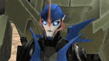 a close up of a robot with blue eyes standing next to another robot