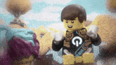 a lego man with a g on his chest