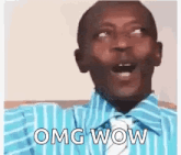 a man in a blue striped shirt and tie is making a funny face and saying `` omg wow '' .