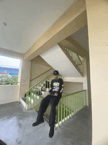a person sitting on a set of stairs wearing a shirt that says snoopy